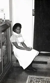 Black student nurse sitting on the step inside Womans Hospi