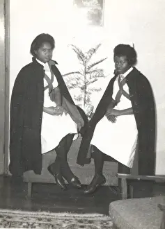 Capes Prints: Two black student nurses sitting by a plant in the Womens H