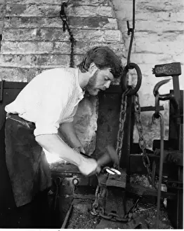 Shirt Sleeves Prints: Blacksmith in his forge, working on a horseshoe
