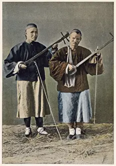 Two blind beggars playing stringed instruments. Date: 1890s