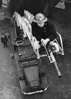 Blitz in London -- AFS firefighter on ladder, WW2