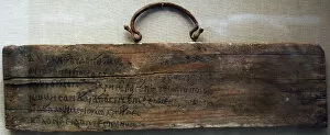Board of wood inscribed in ink with lines 468-473 of Book I