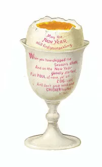 Boiled egg in an eggcup on a cutout New Year card