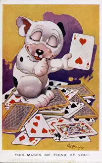 Bonzo sitting in a pile of playing cards