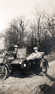 Boy on 1920 Royal Enfield motorcycle combination with passen Boy on 1920 Royal Enfield motorcycle combination with passen