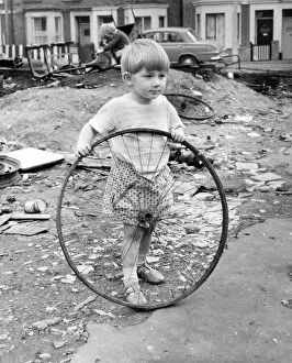 Junk Collection: Boy with bicycle wheel, Balham, SW London