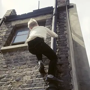 Urchins Prints: Boy climbing drainpipe on a Balham house, SW London