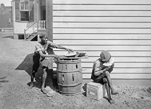Steals Prints: Boy eating watermelon while his friend steals a piece in Ame