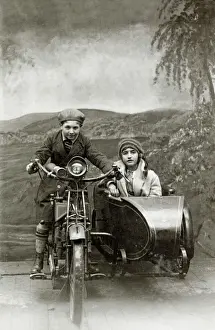Bikes Prints: Boy & girl on a 1922 Royal Enfield motorcycle & sidecar in a