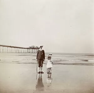 Reflection Collection: Boy and girl on the beach, Saltburn, North Yorkshire