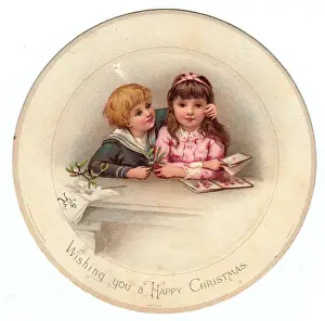 Boy and girl with mistletoe on a circular Christmas card