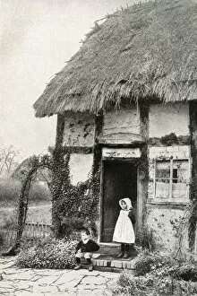 Calm Gallery: Boy and girl outside a thatched cottage, Worcestershire