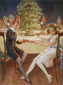 Pull Prints: Boy and girl in paper hats pull a cracker at the party table Date: circa 1929