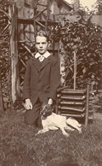 Russell Gallery: Boy with a Jack Russell terrier in a garden