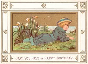 Daffodils Gallery: Boy lying on grass on a birthday card