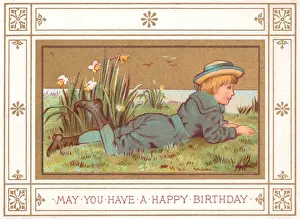 Daffodils Prints: Boy lying on grass on a birthday card