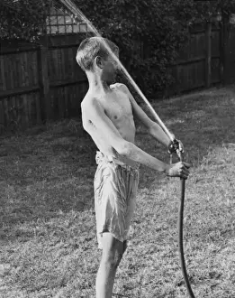 Cubs Prints: Boy plays with water hose 1933