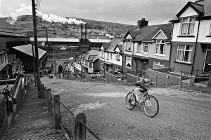 Boy pushes his bicycle up a hill in Ebbw Vale South Wales