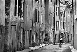 Images Dated 2nd July 2019: Boy riding his bicycle down a street in Cevannes, France