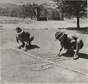 Creating Gallery: Boy scouts creating a design on the ground, Greece