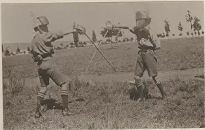 Two boy scouts fencing at camp