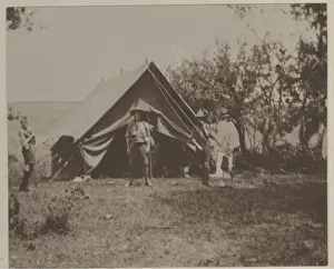 Boy scouts in front of tent at camp