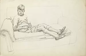 Lounging Gallery: Boy sitting on a two-seat sofa