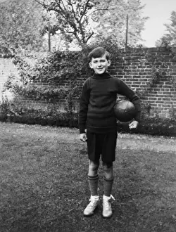 Fist Prints: Boy standing in garden with rugby ball, Eltham, London