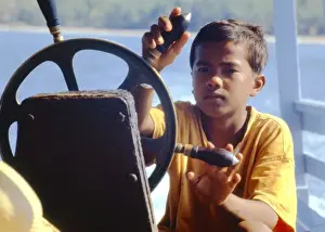 Teeshirt Prints: Boy steering a boat, Thailand
