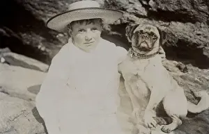 Boy in straw hat with dog