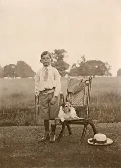 Boy with a terrier dog in a garden