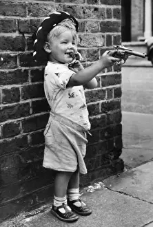 Grinning Prints: Boy with toy gun and cowboy hat, Balham, SW London