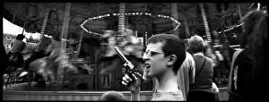Boy with toy gun at a fairground, London, England