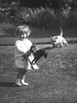 Boy with a toy horse in a Devon garden