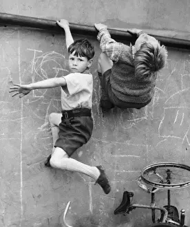 Urchins Prints: Two boys climbing wall on a Balham street, SW London