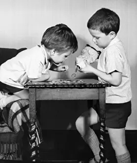 Two boys emptying a piggy bank