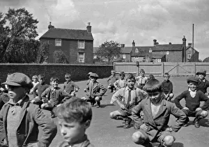 Squat Prints: Boys exercising in school playground