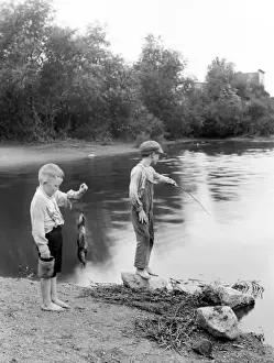 Boys fishing at a lake in Summit, Illinois, USA