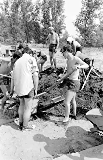 Boys and girls, supervised by a man, taking part in a Communist Youth labour camp in