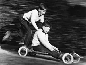 Two boys on a home-made go-kart