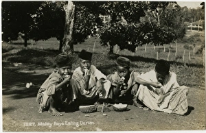 Images Dated 2nd November 2016: Boys in Malaysia eating Durian Fruit