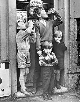 Bottles Collection: Boys outside a sweet shop, Balham, SW London