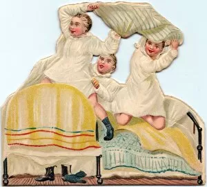Three boys pillow fighting on a cutout greetings card