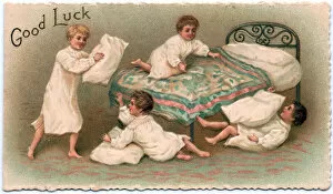 Four boys pillow fighting on a Good Luck card