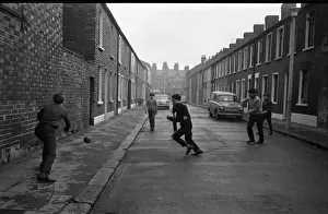 Boys playing football in a street, Belfast, Northern Ireland