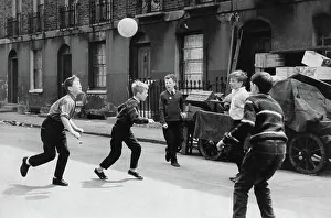 Boys playing football in the Street taken on Grant Street, Islington, London N1. This road ran parallel to Chapel Street Market. Date: 1961