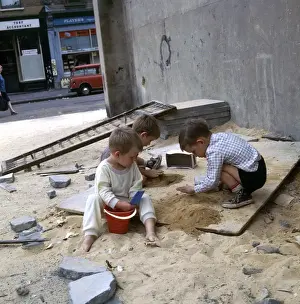 Urchins Prints: Three boys playing with sand in a Balham street, SW London