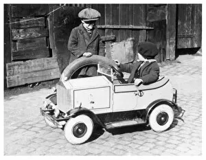 Boys playing with toy car, 1930s