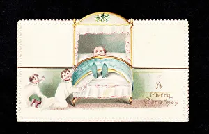 Two boys tickling a man's feet on a Christmas card