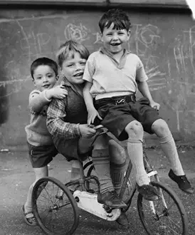 Boys on a tricycle in a Balham street, SW London